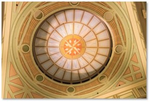 Next, look up and you’ll see another mural on the ceiling that adds the illusion of a light-filled dome surrounded by eight medallions with a compass rose at the center.