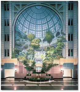This vertical garden mural is six stories high and takes up one entire wall of the building’s multi-level atrium. It draws us into a Victorian crystal garden with a multitude of tropical plants growing in front of elaborate arches and balconies, under an ornate glass dome. A fountain runs down and wild animals peer from between the branches. At the mural’s base, a real fountain, bracketed by real trees, provides the garden music of tinkling water.