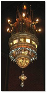 This spectacular lantern was designed by Jacob A. Holtzer and is made of art glass and bronze filigree with dangling glass balls.