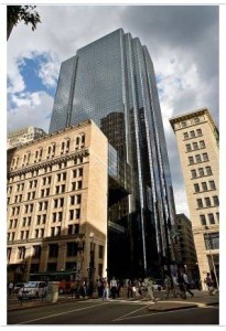 Although they could not, in the end, protect the entire building they did succeed in saving a 60-foot, L-shaped portion of the façade. The office tower, walled in blue reflective glass, rises behind it.