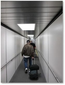 Airplane jetway, passengers boarding, airport
